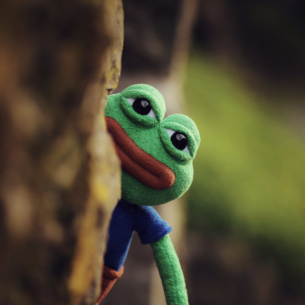 Pepe the frog creeping behind a tree